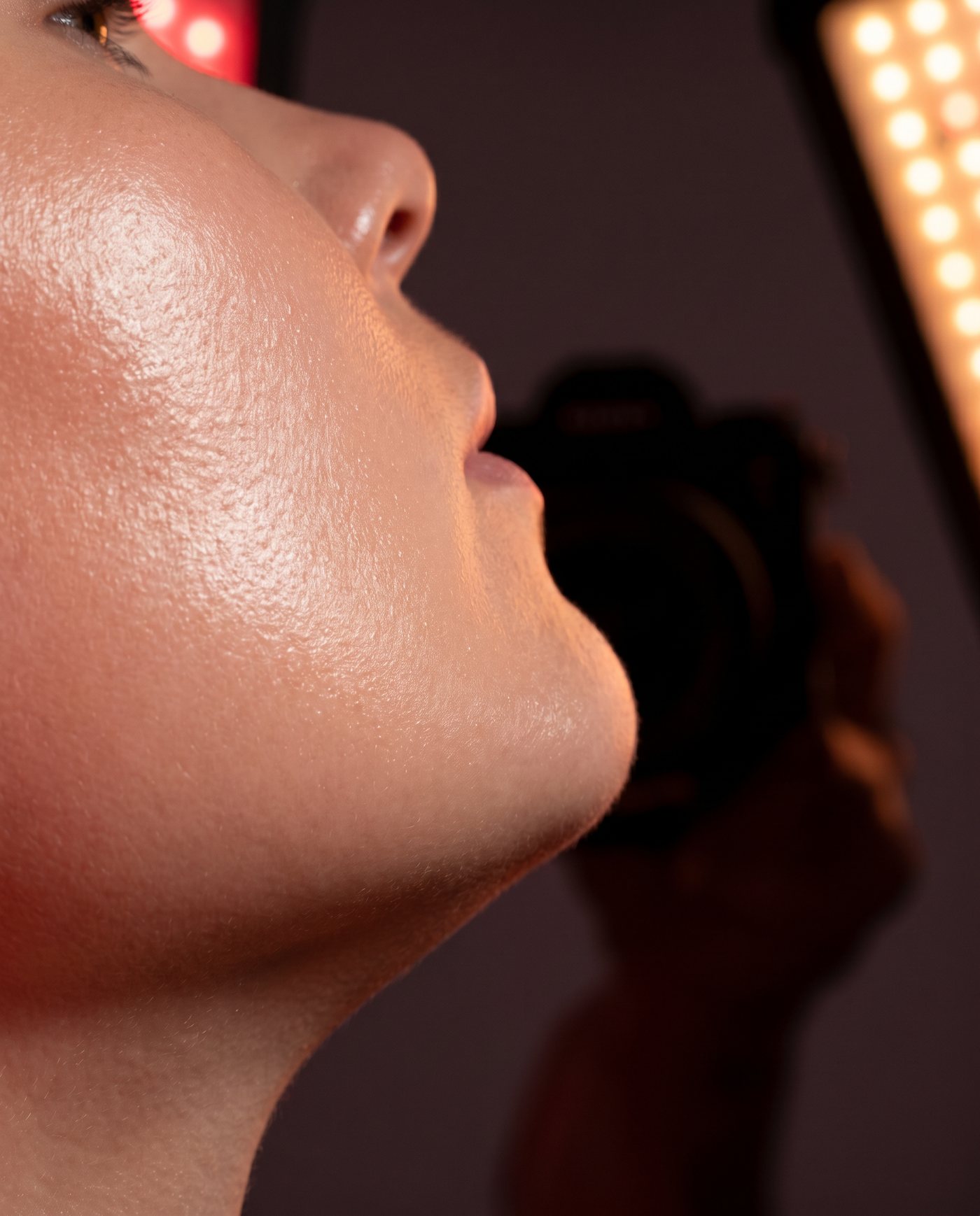 Close-up of healthy skin bathed in warm red light